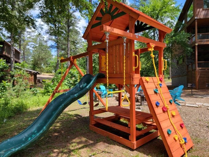 A playground with a slide and a climbing wall