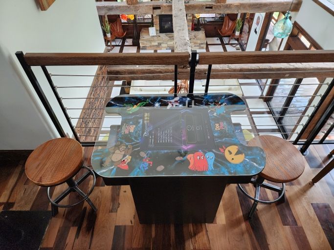 A table with two stools and a game on it