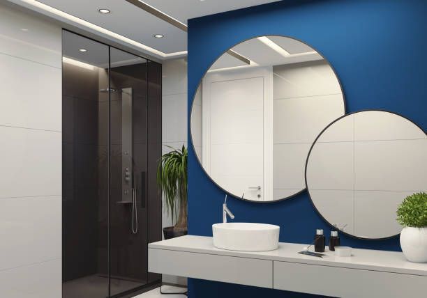 A bathroom with two round mirrors and a sink