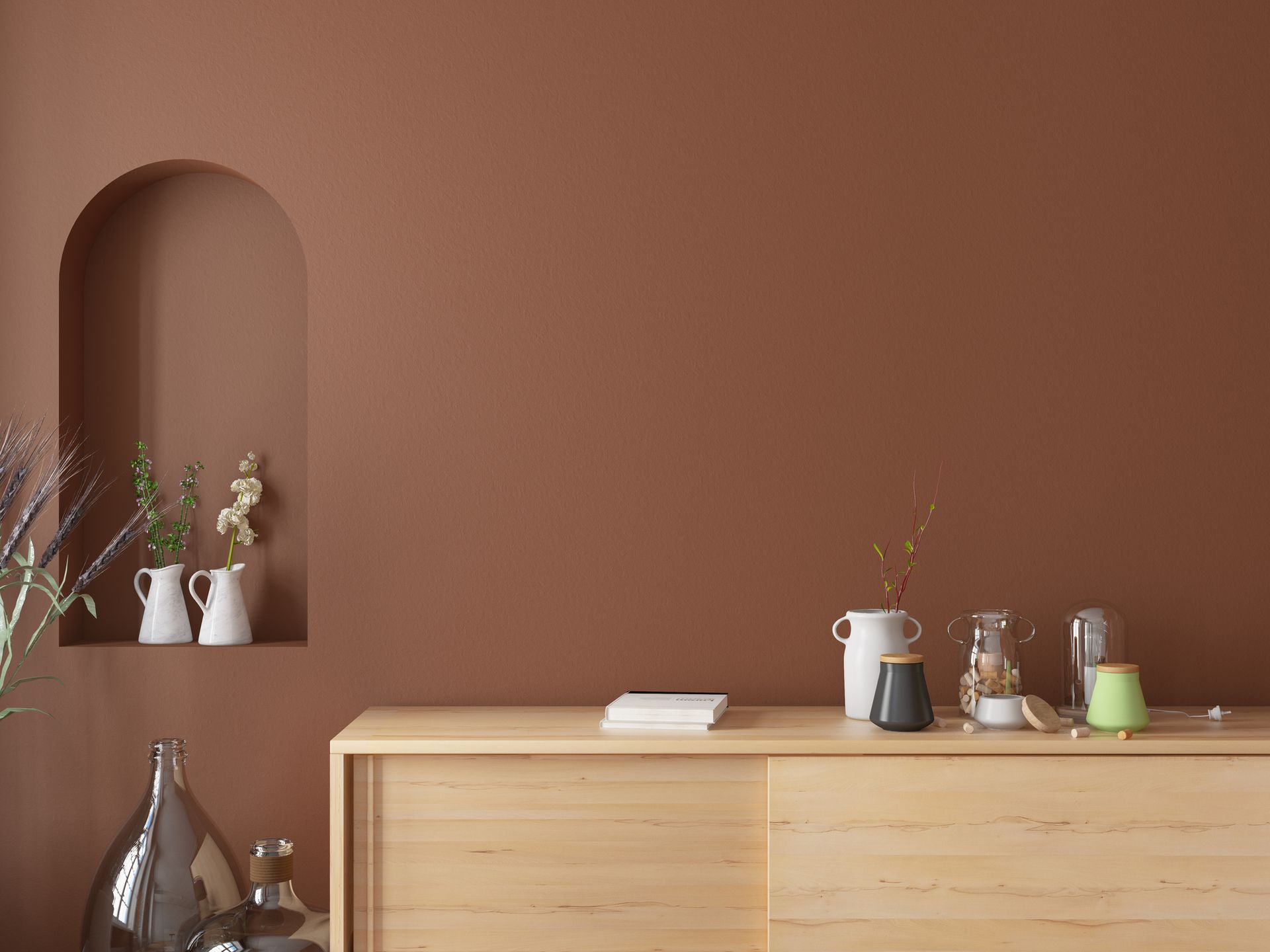 A wooden dresser with vases on it in a living room with a brown wall.