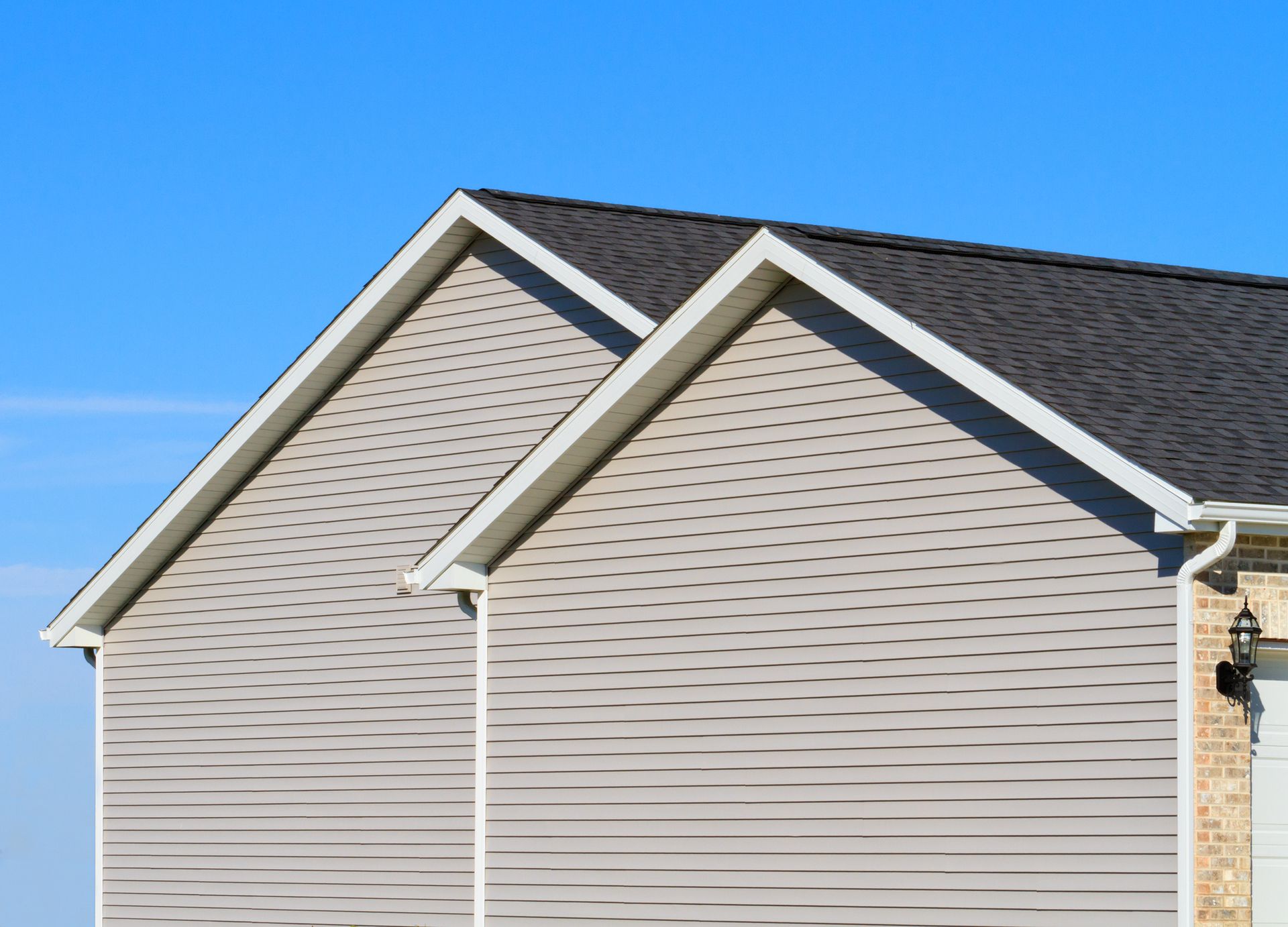 The roof of a house with a blue sky in the background