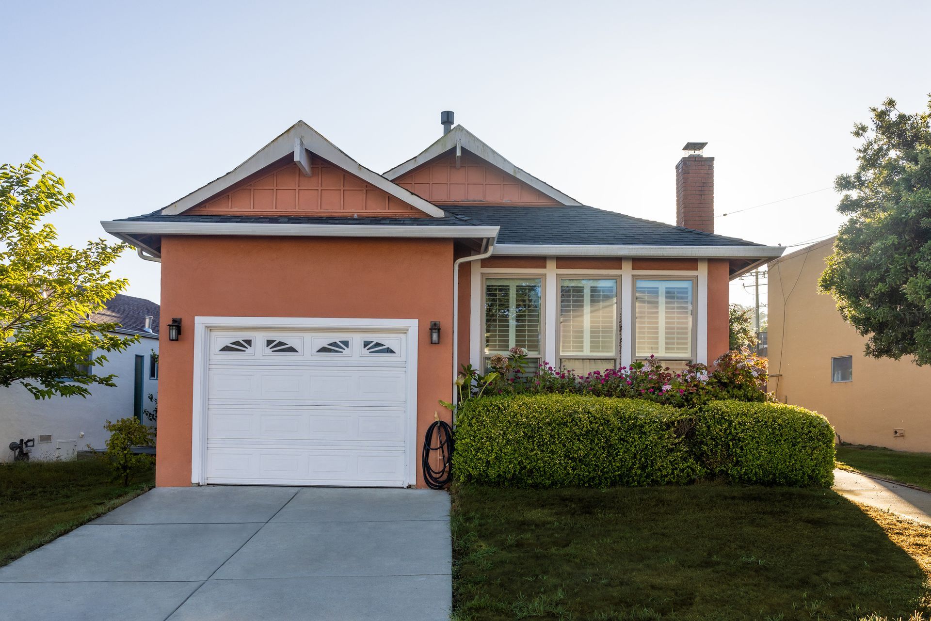 An orange house with a white garage door