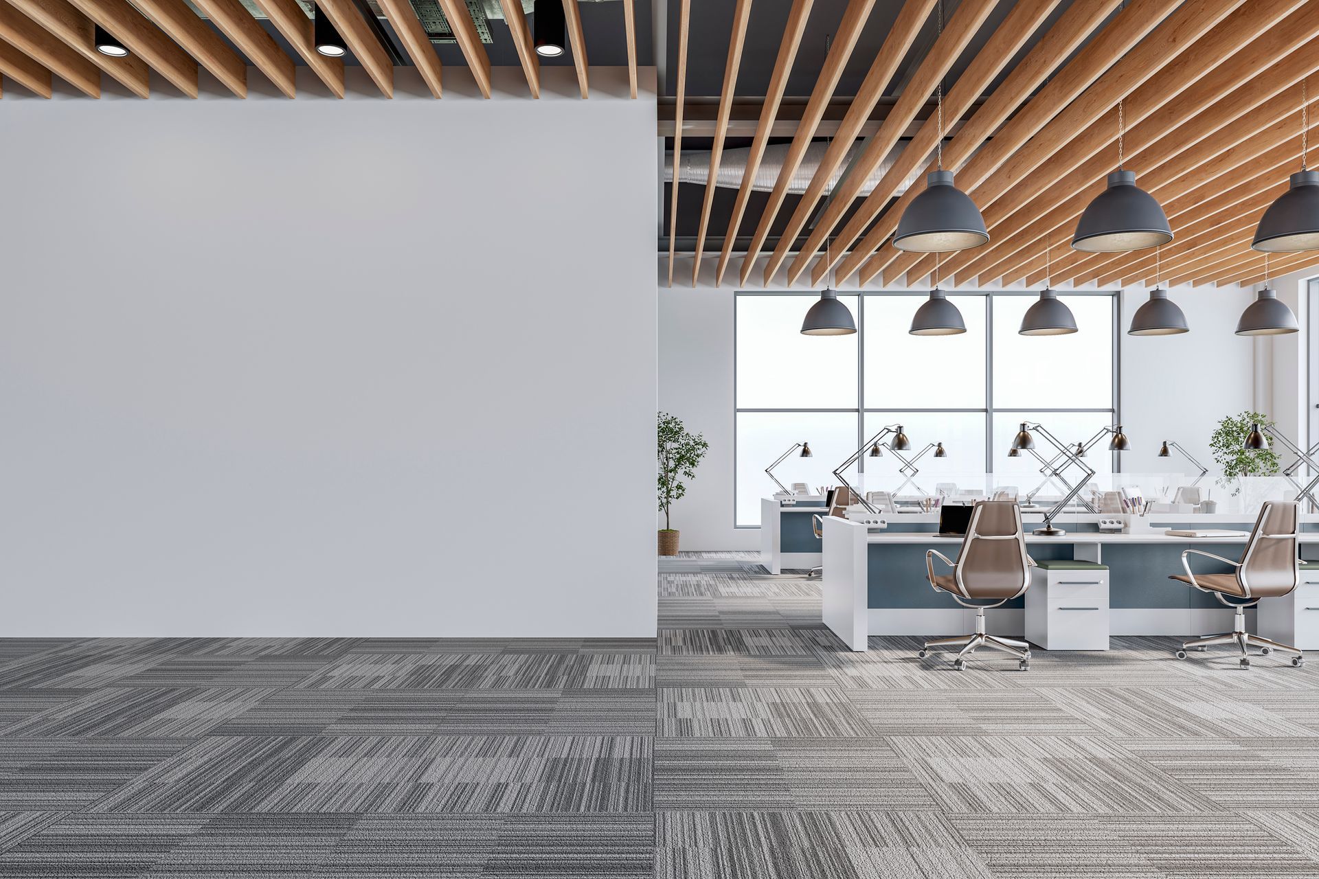 A modern office with a carpeted floor and a white wall.