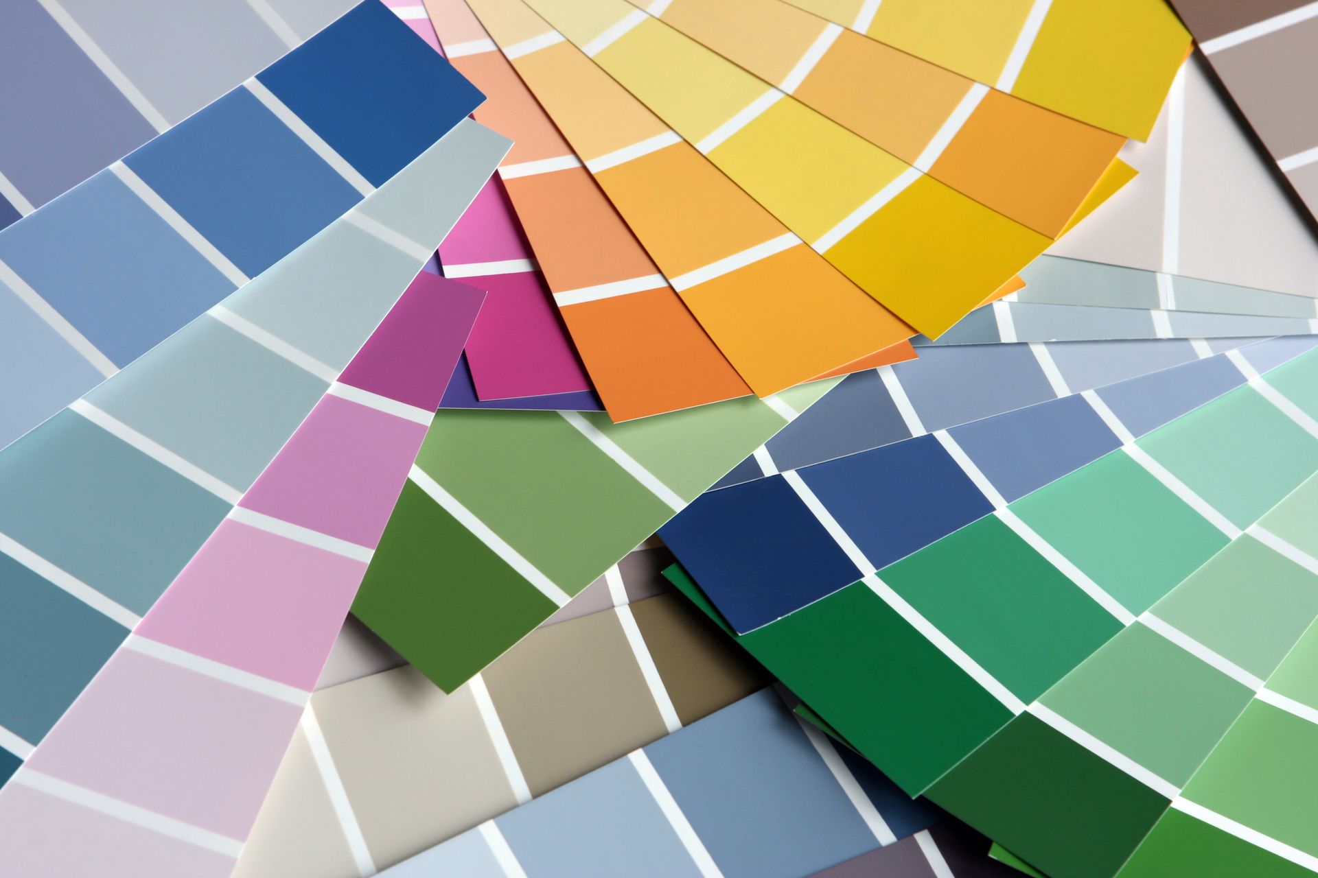A bunch of different colored paint samples are stacked on top of each other