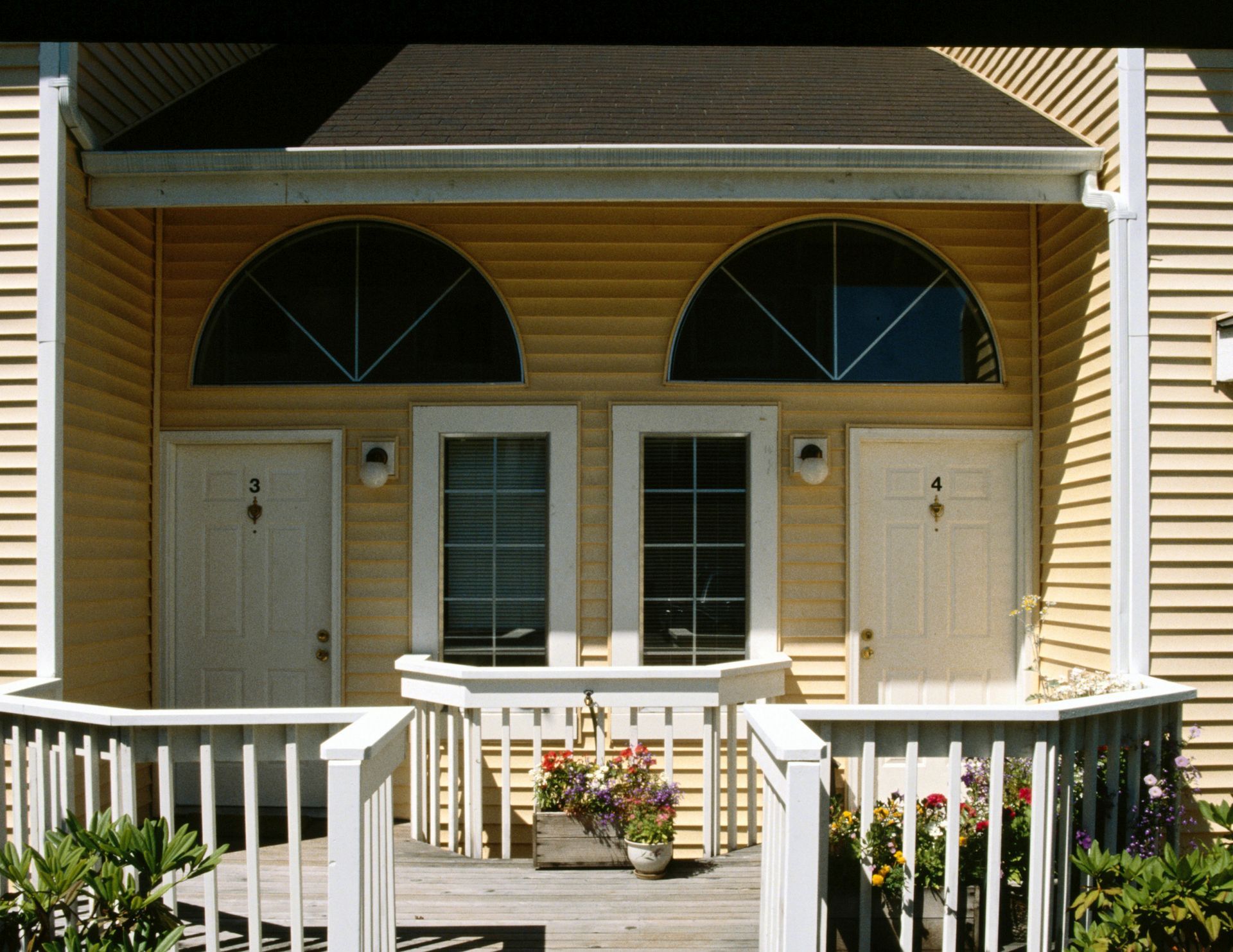 A house with a porch and a planter of flowers