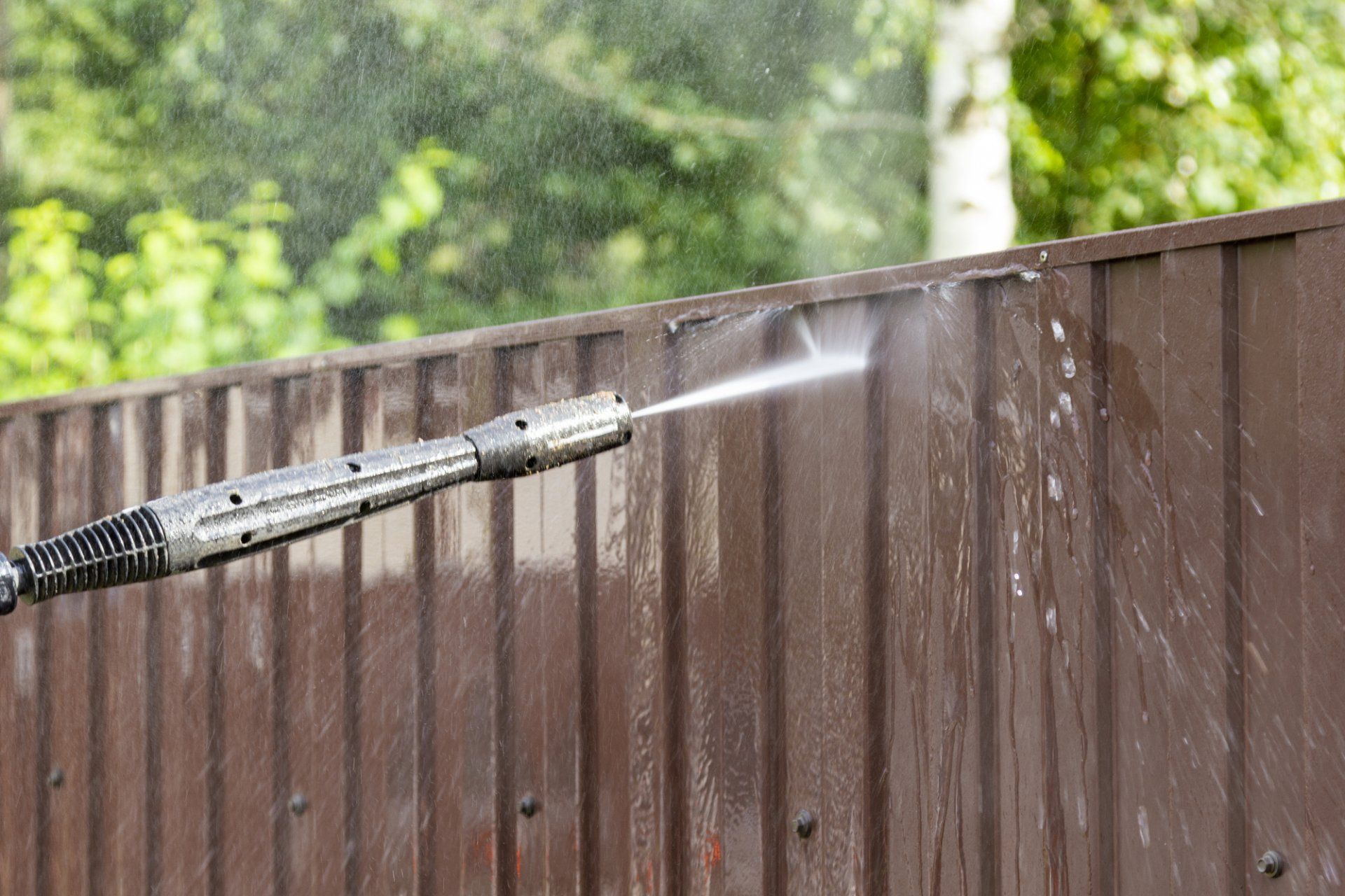 metal fence being pressure washed in Fayetteville AR