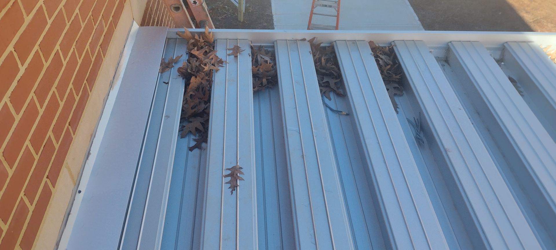 A white awning is sitting on the side of a building.