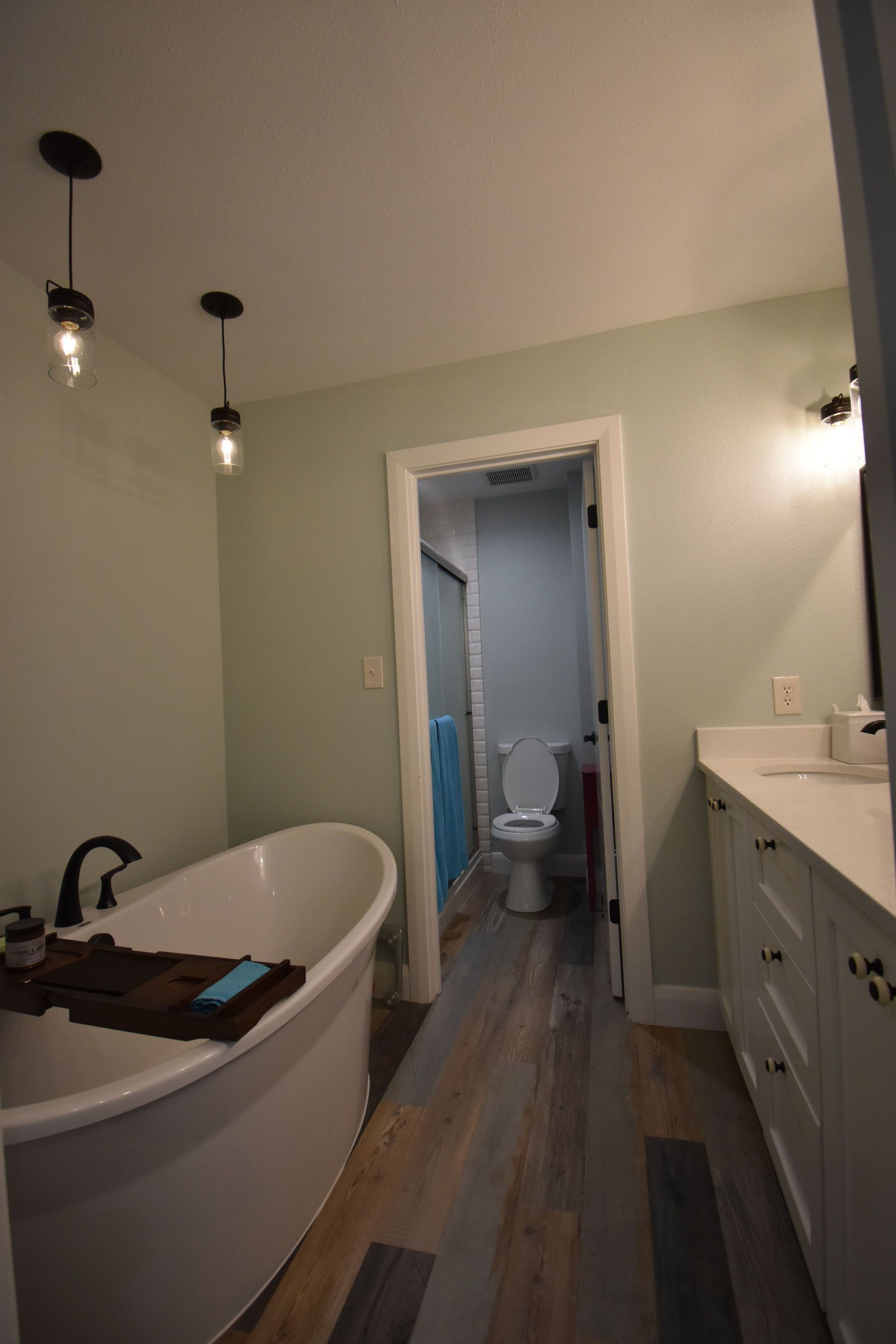 A bathroom with a bathtub , toilet and sink.