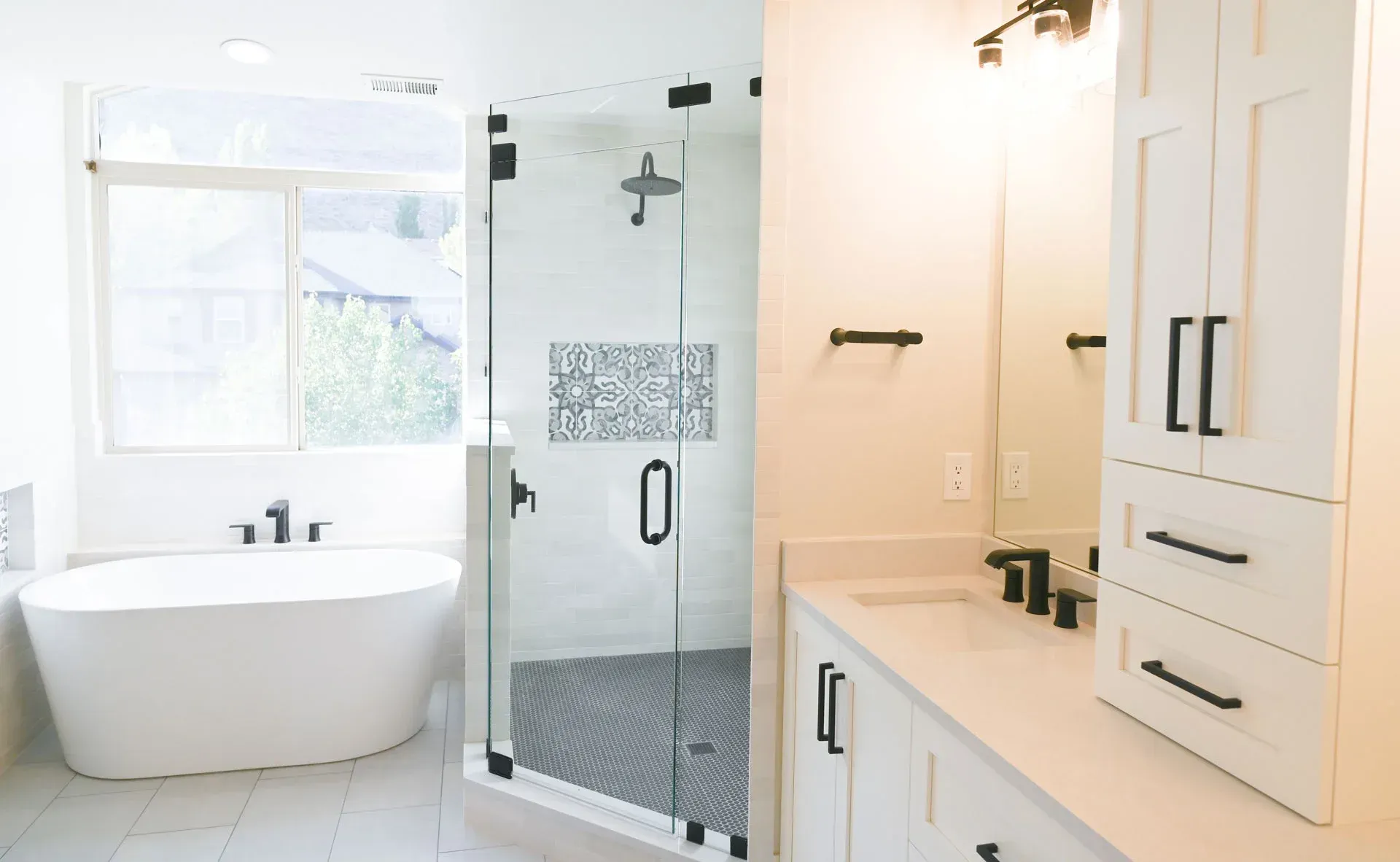 A bathroom with a tub , sink , and shower.
