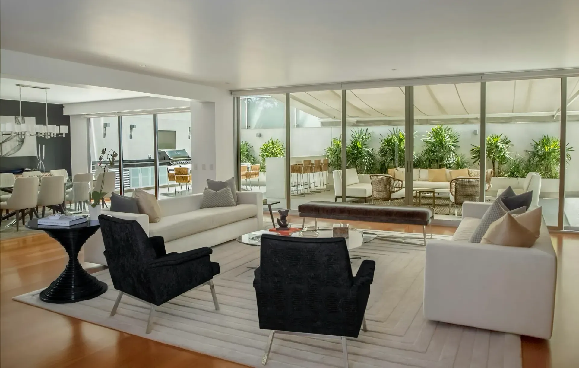 A living room with a couch , chairs and a table