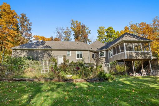 A kitchen with wooden cabinets , granite counter tops , stainless steel appliances and a large island.