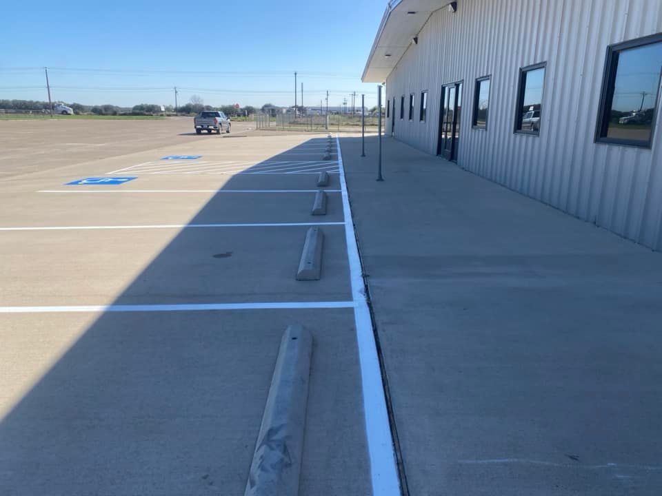 A car is parked in a handicapped parking spot in front of a building