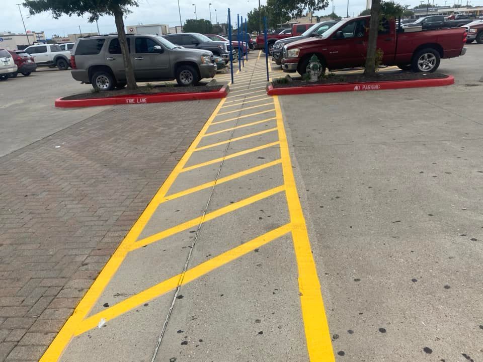 A parking lot with yellow lines painted on the ground