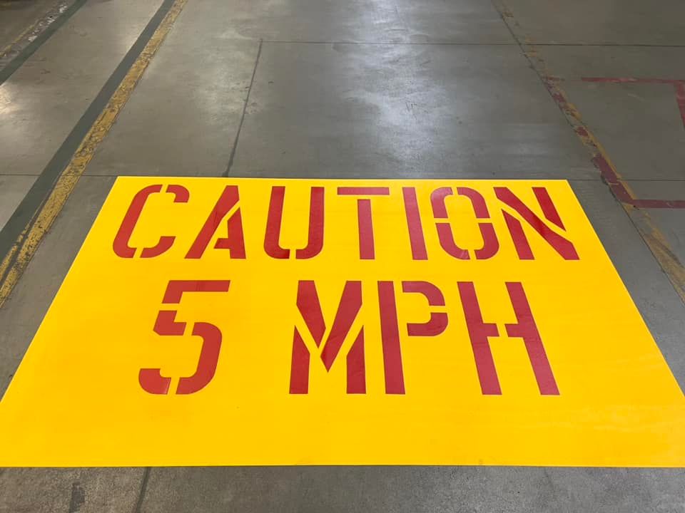 A yellow and red sign that says caution 5 mph