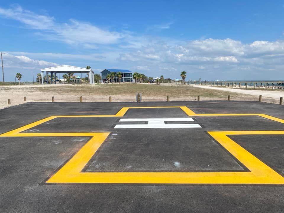 A helicopter landing strip with a white h on it