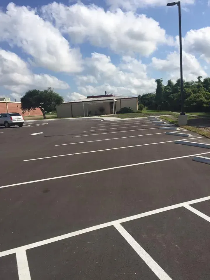 A parking lot with a building in the background