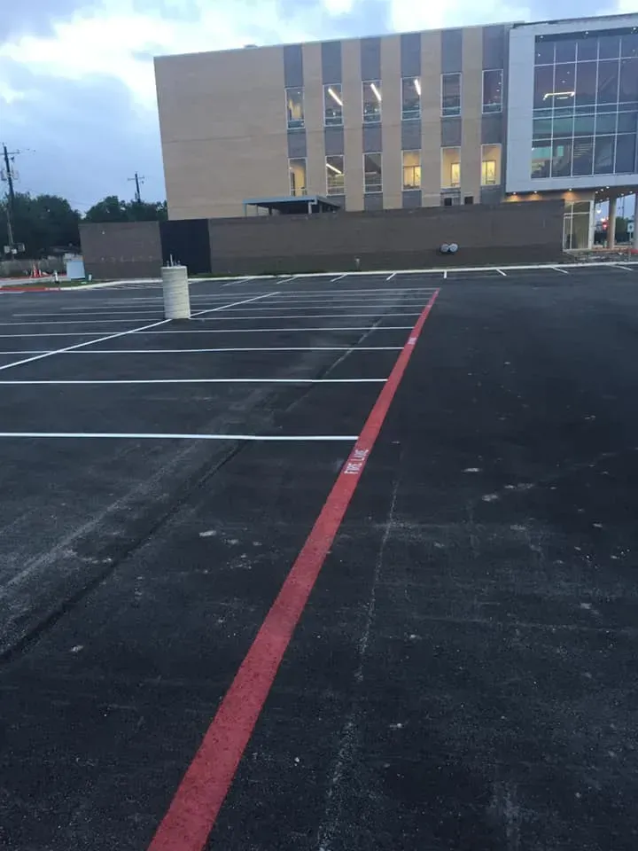 A parking lot with a large building in the background