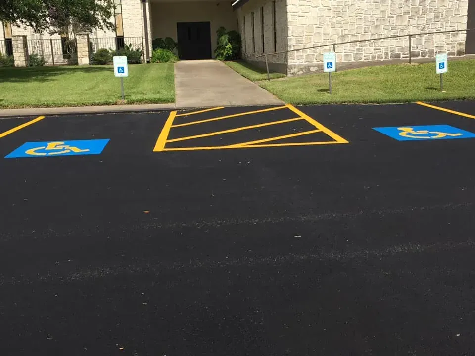 A parking lot with handicap signs painted on it