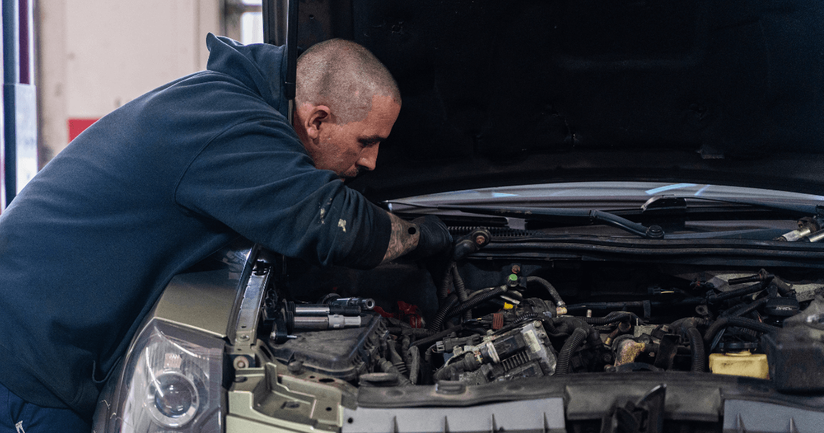 a mechanic doing an auto repair at home