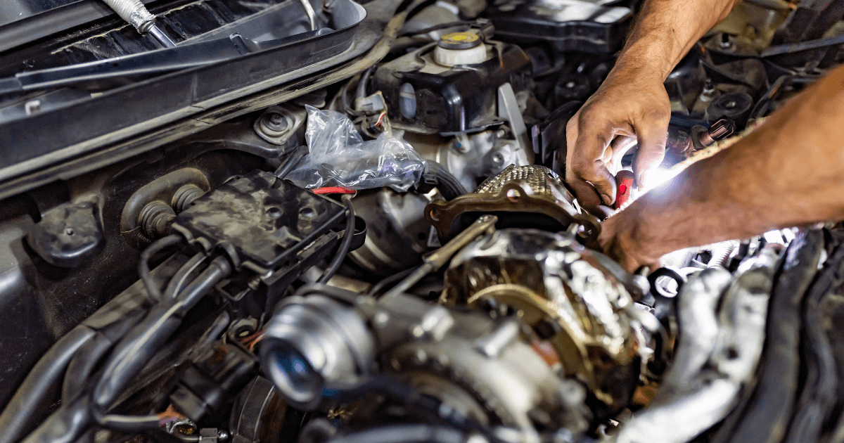 a mechanic doing a repair under the hood of a car