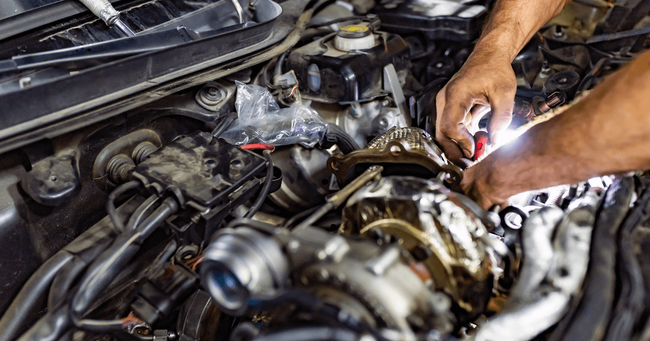 a mechanic doing a repair under the hood of a car