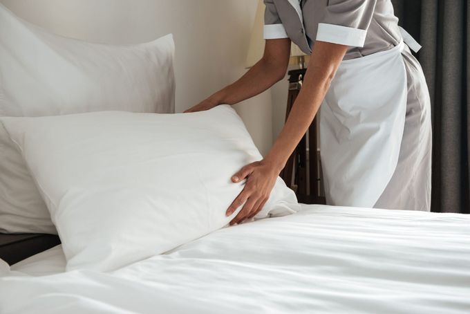 maid in aurora housekeeping pic of housekeeper fluffing pillow