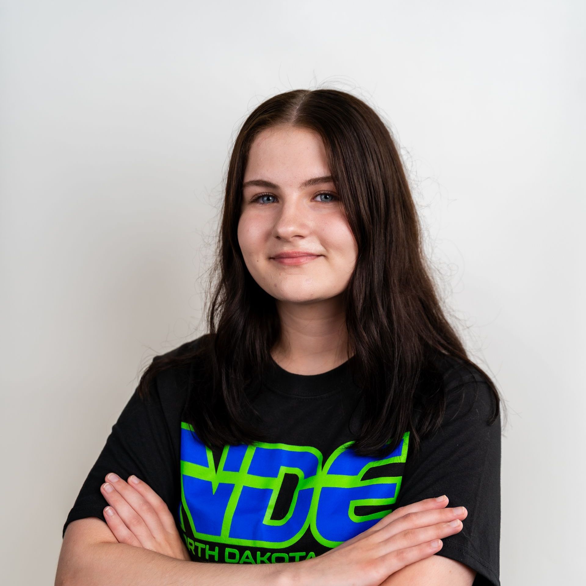 A woman wearing glasses and a black shirt with the word elite on it