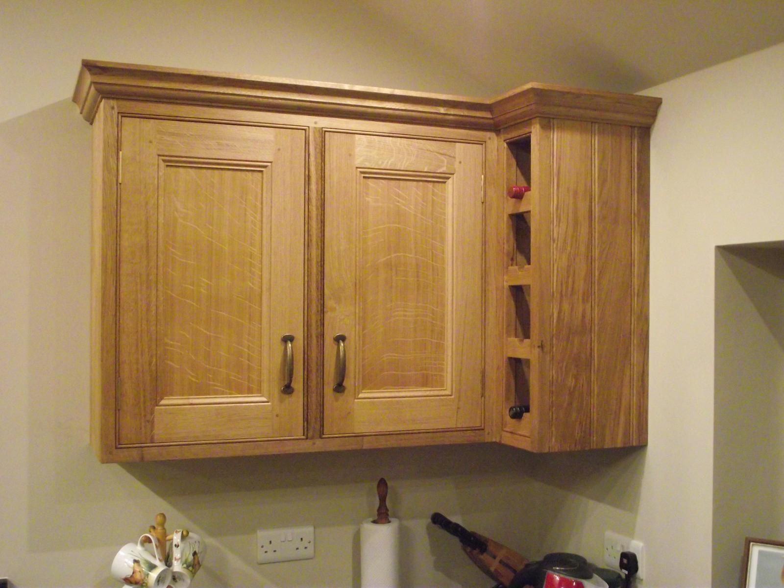 A kitchen with wooden cabinets and a wine rack