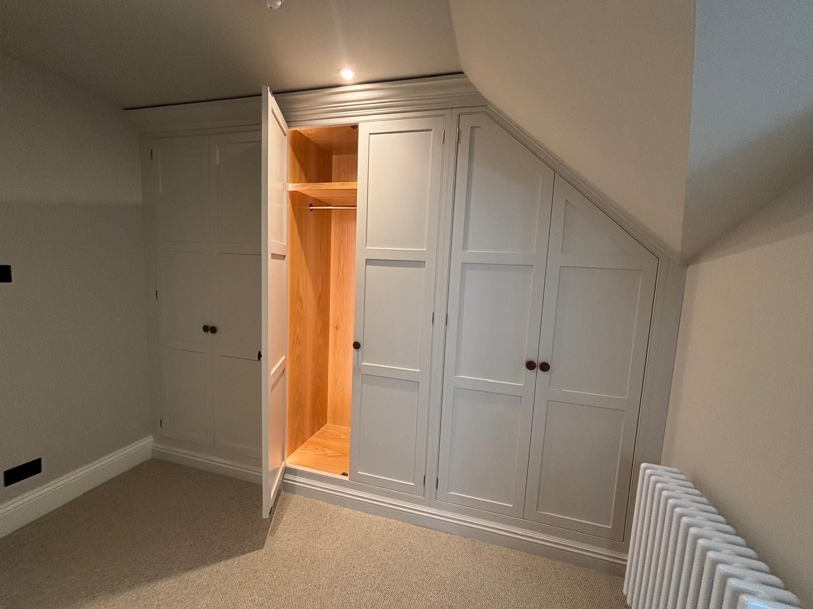 A room with a closet and a radiator in it.
