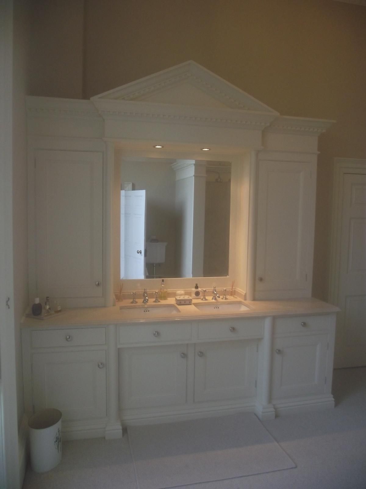 A bathroom with two sinks and a large mirror