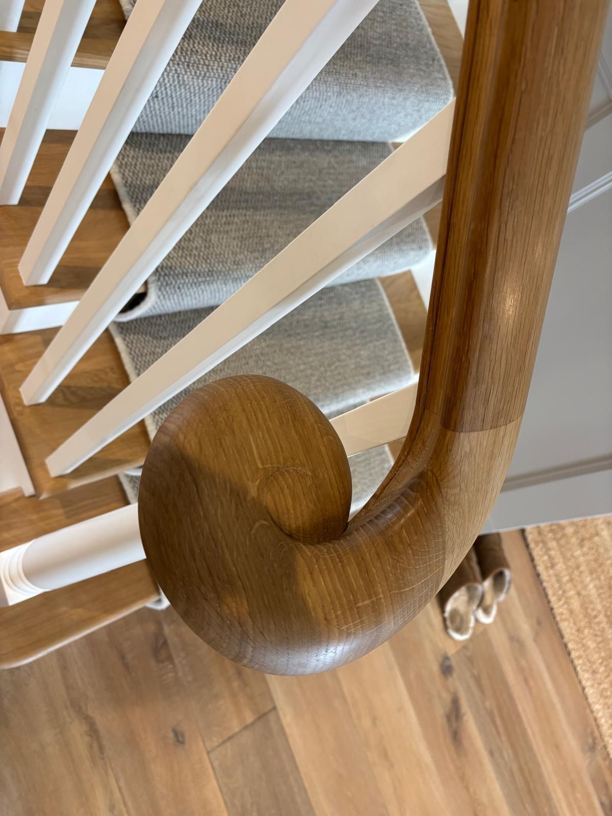 A close up of a wooden handrail on a staircase.