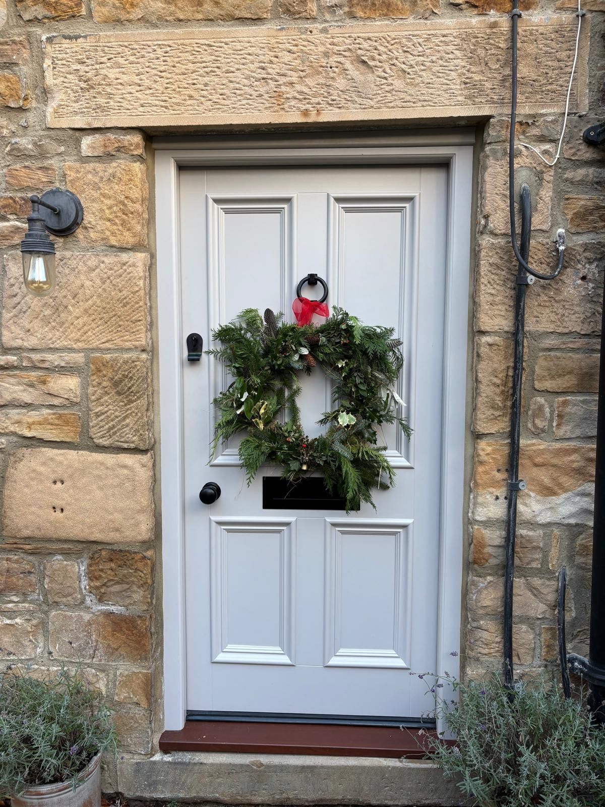 A white door with a christmas wreath on it