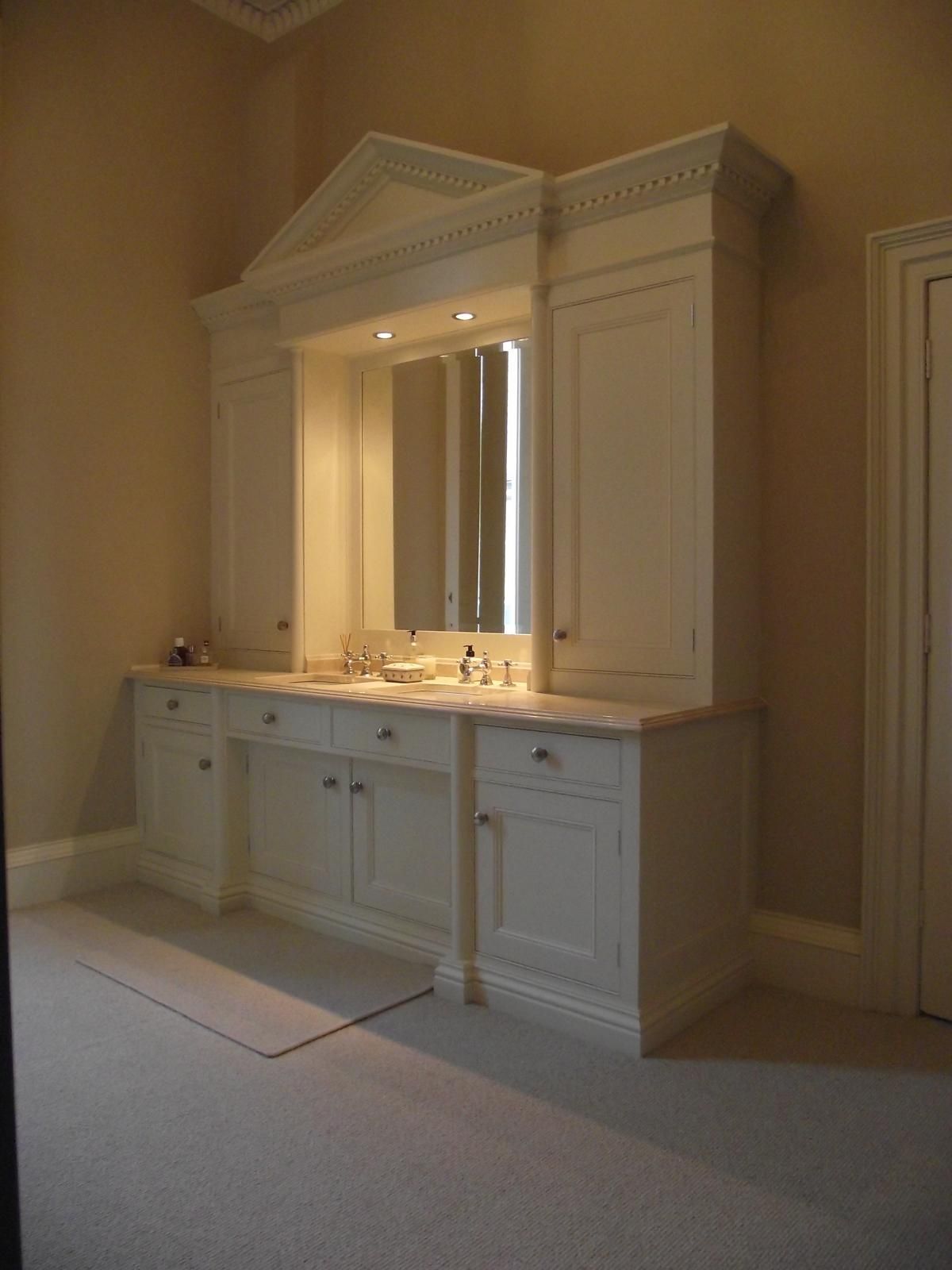 A bathroom with two sinks and a large mirror