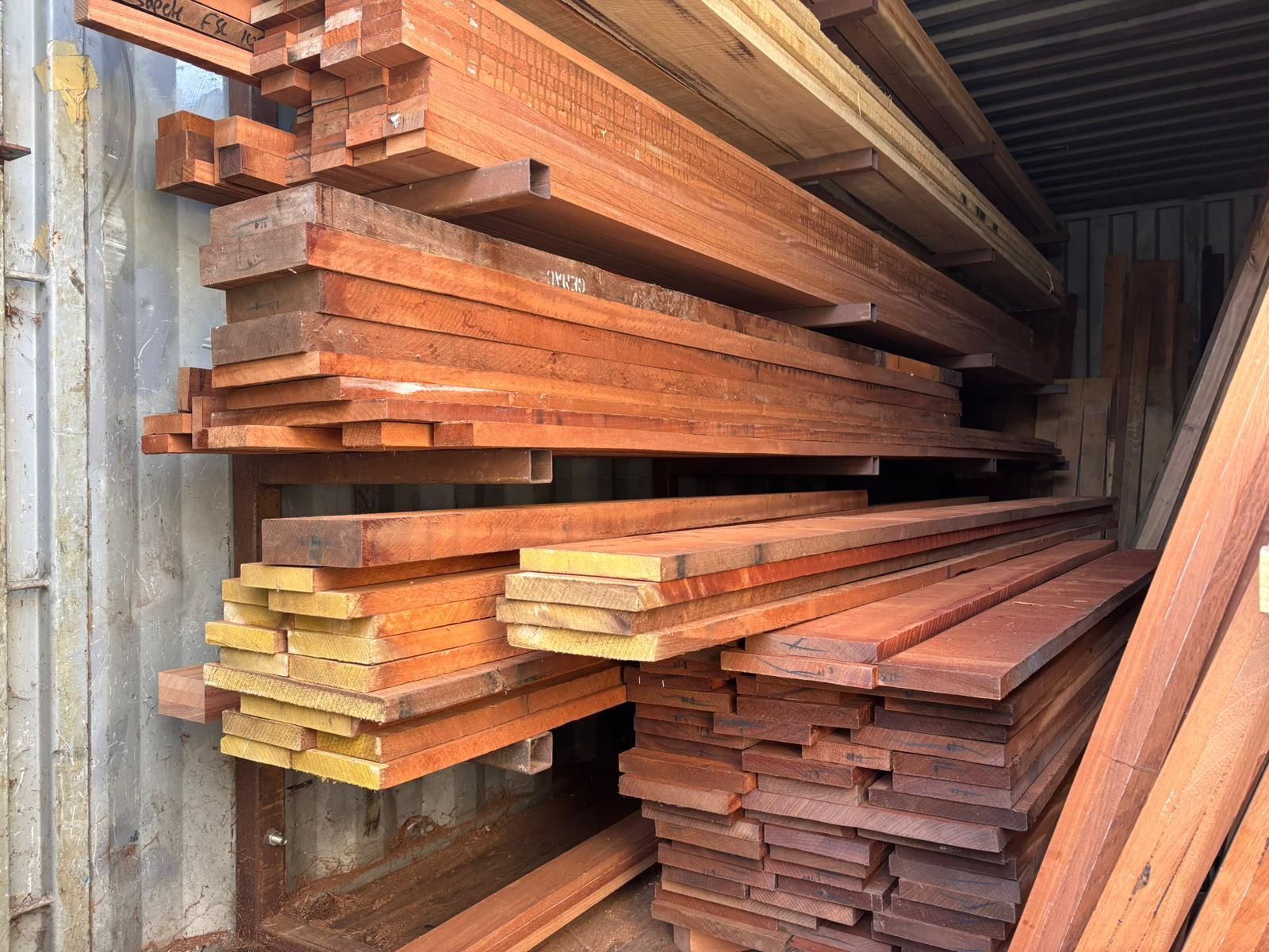 A pile of wood is stacked on top of each other in a warehouse.