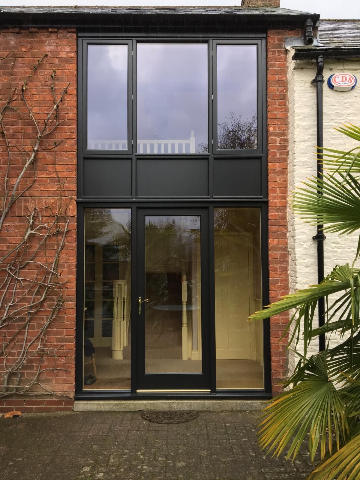 A brick building with a black door and windows