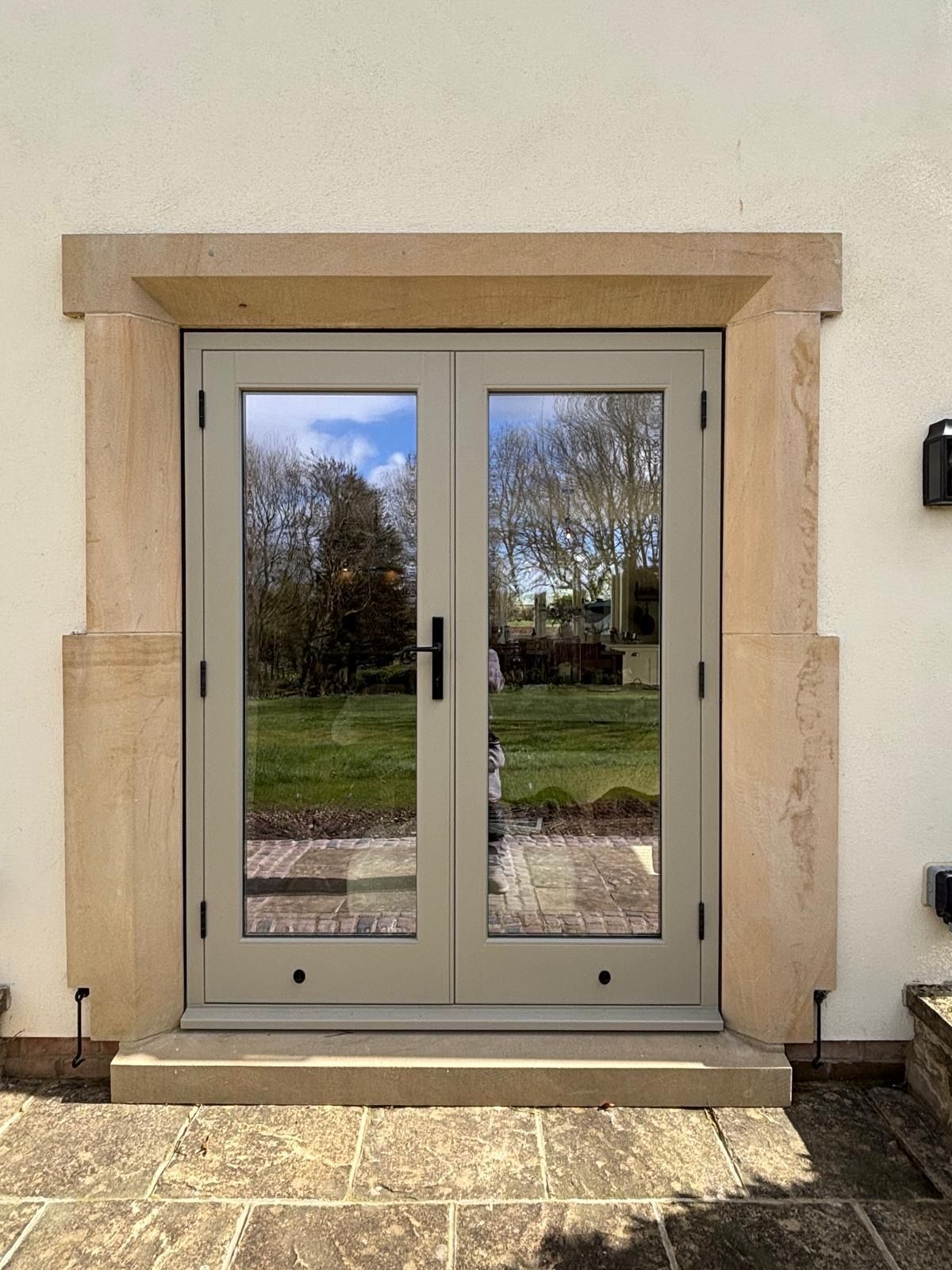 A pair of french doors on the side of a building.