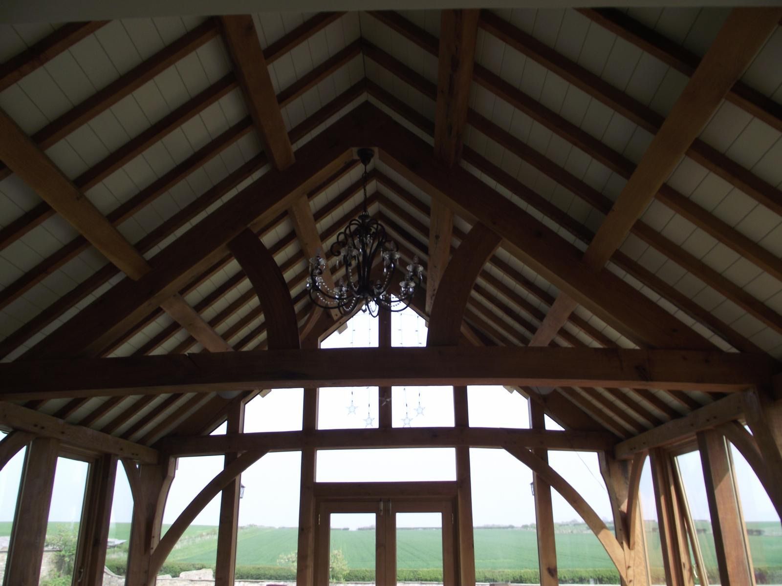 The ceiling of a building with a chandelier hanging from it