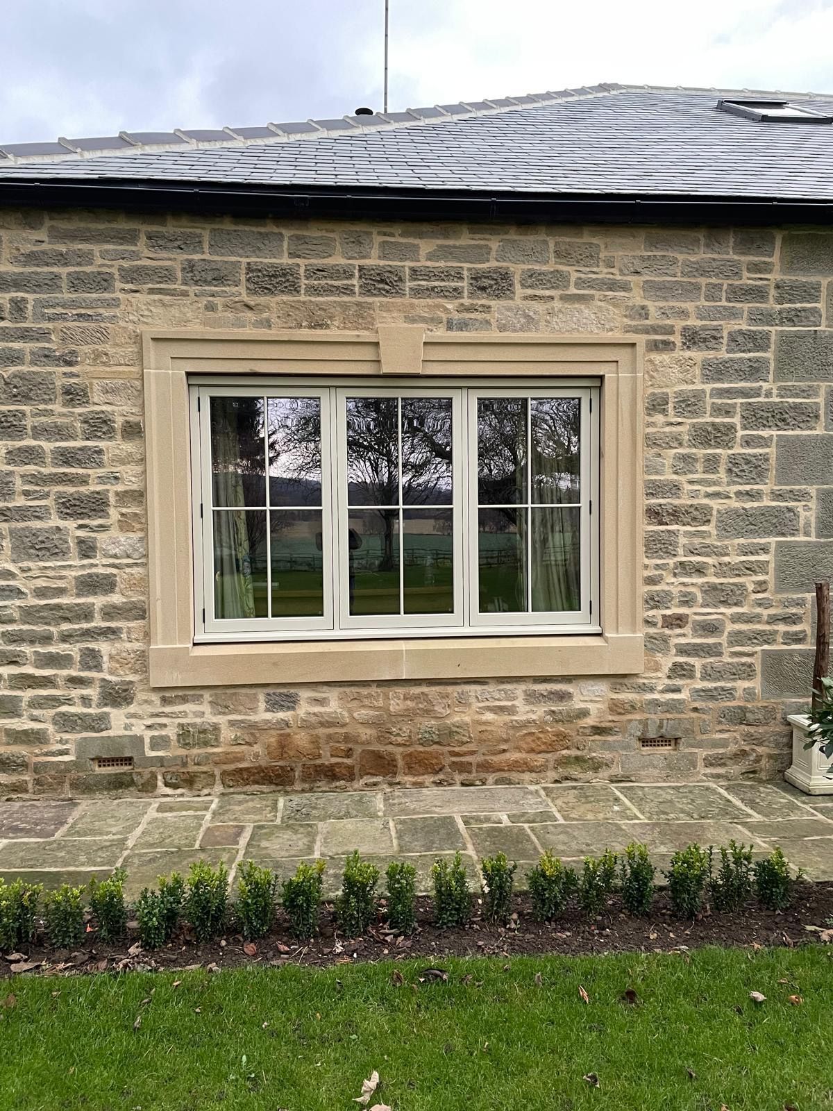 There is a large window on the side of a brick building.