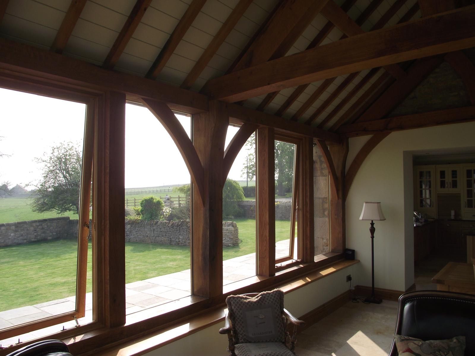 A living room with lots of windows and a lamp