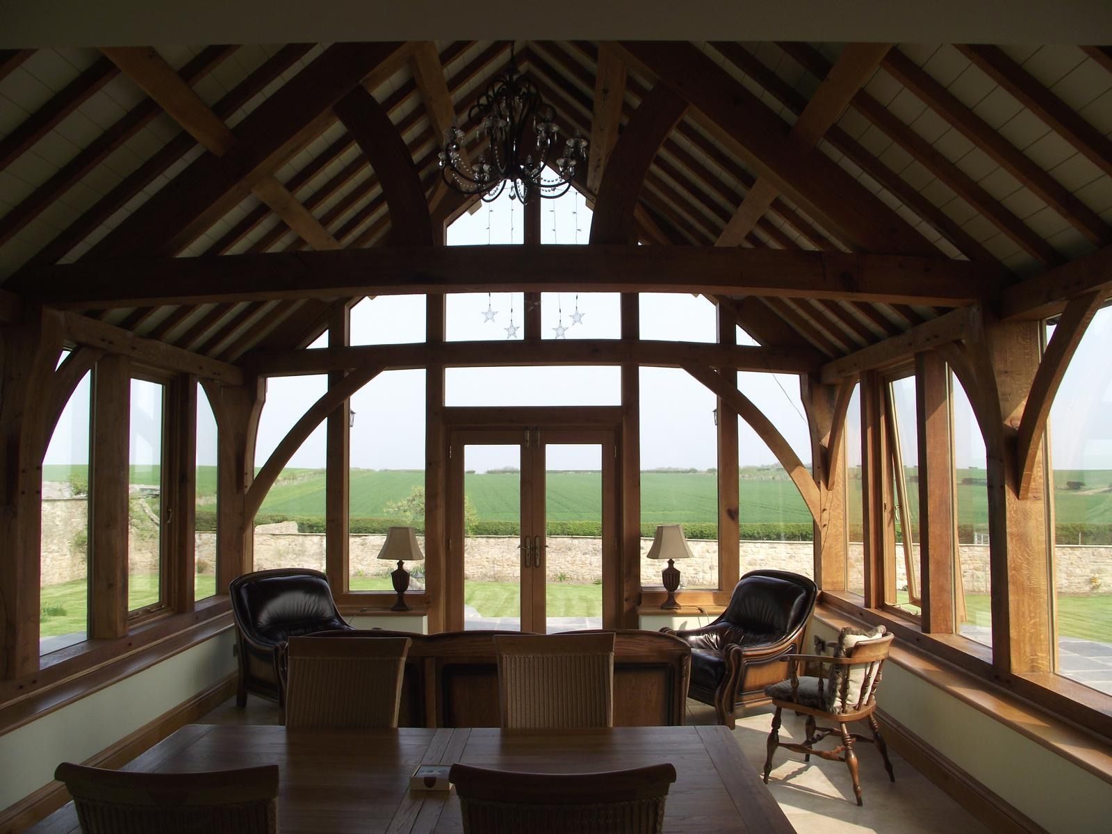 A large room with lots of windows and a table and chairs