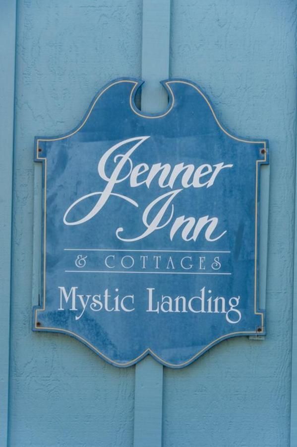 Sign for Jenner Inn & Cottages, Mystic Landing, blue and white on a light blue background.