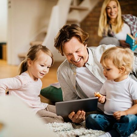 Family using ipad to pay their rent online