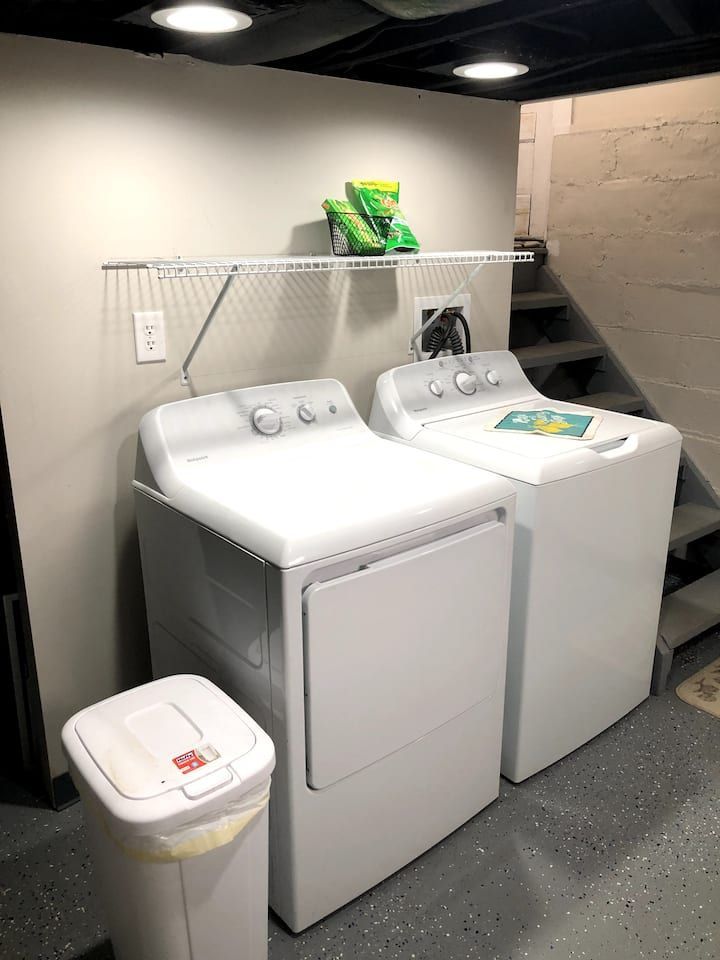 A washer and dryer are sitting next to each other in a laundry room.