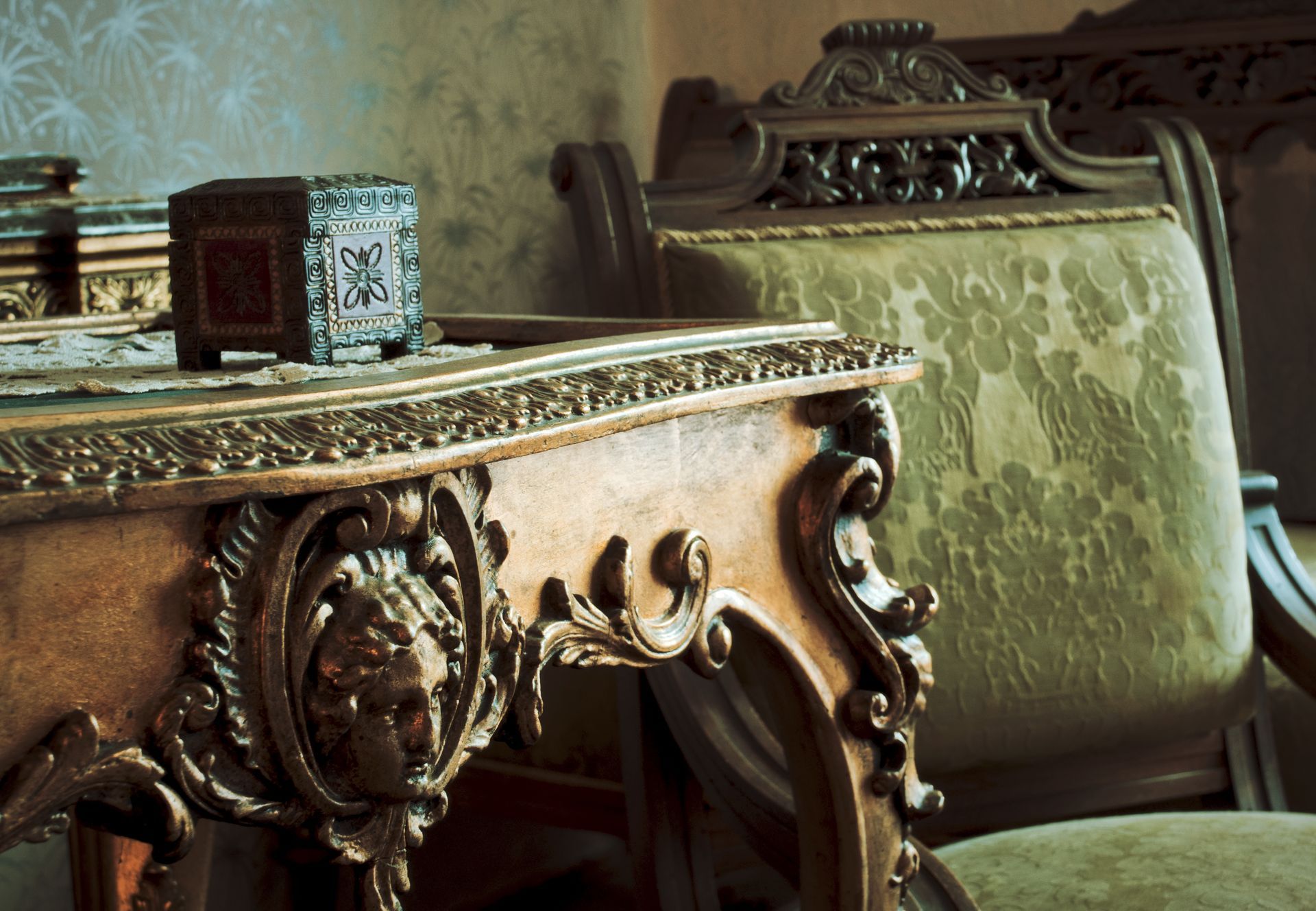A carved wooden table with a lion head on it