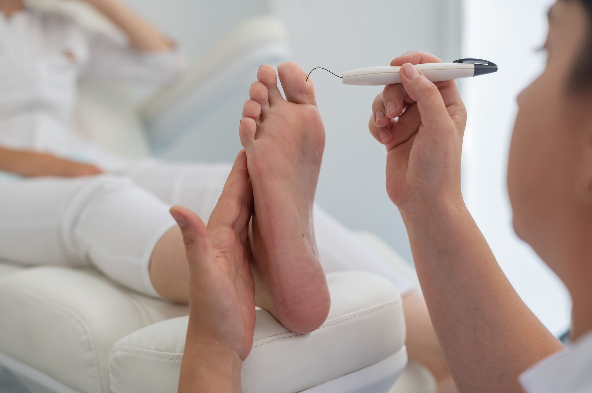 A Woman is Giving a Foot Massage to Another Woman — Newcastle Foot & Ankle Clinic Charlestown In Charlestown, NSW