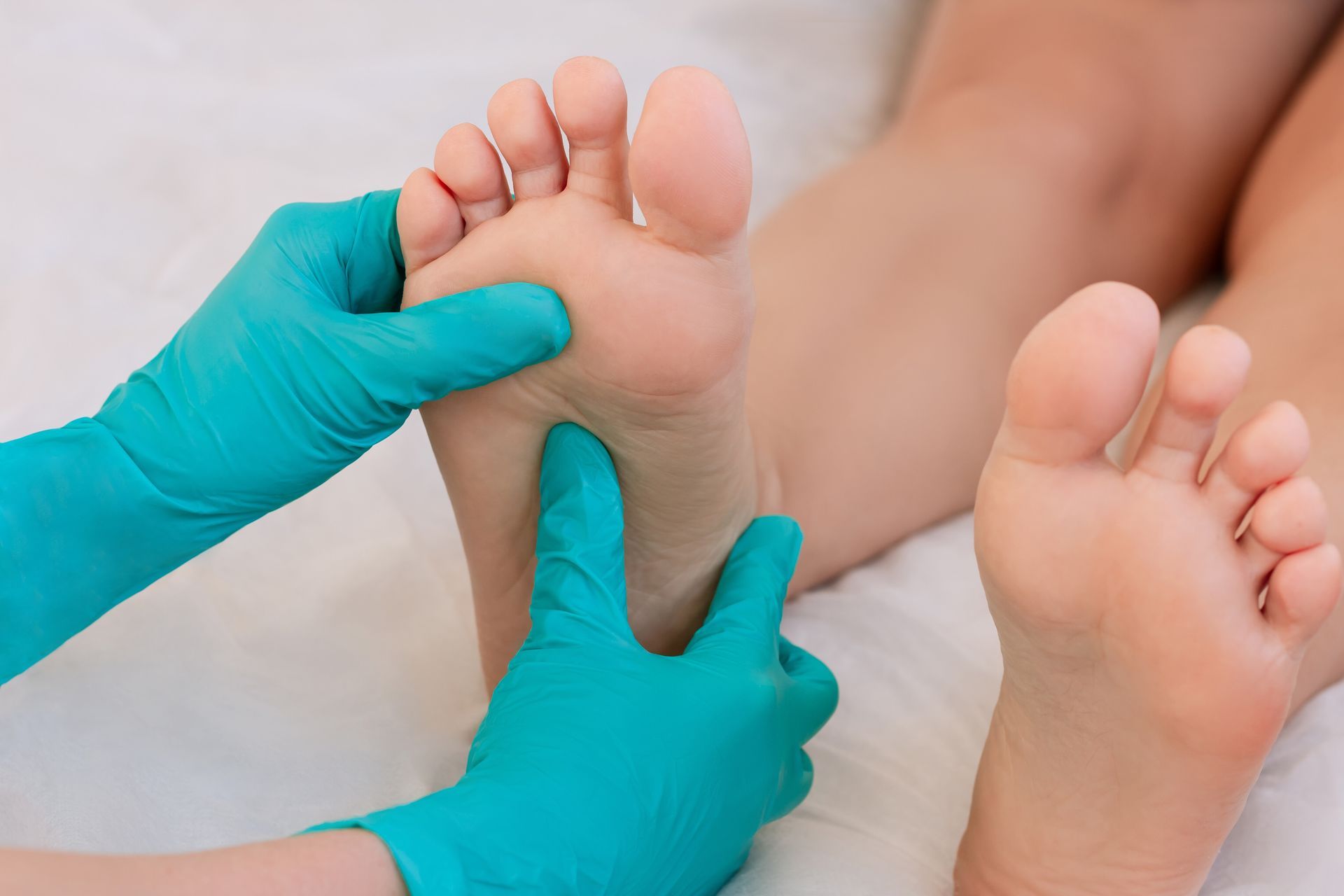 A Person is Getting a Foot Massage From a Doctor — Newcastle Foot & Ankle Clinic Charlestown In Charlestown, NSW