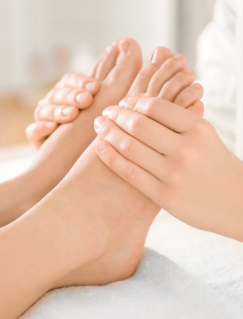 A Woman is Getting a Foot Massage at a Spa — Newcastle Foot & Ankle Clinic Charlestown In Maitland, NSW