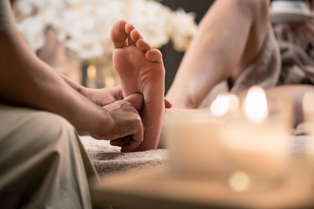 A Woman is Getting a Foot Massage in a Spa — Newcastle Foot & Ankle Clinic Charlestown In Maitland, NSW