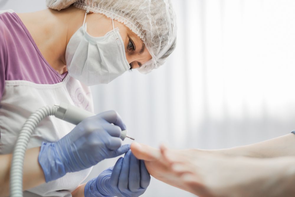 A Woman Wearing a Mask and Gloves — Newcastle Foot & Ankle Clinic Charlestown In Charlestown, NSW
