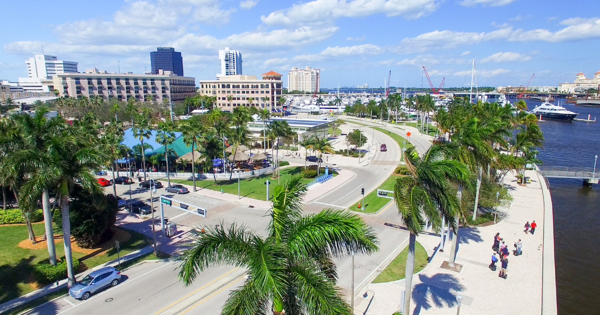 A living room with a couch , chairs , coffee table , fireplace and television.